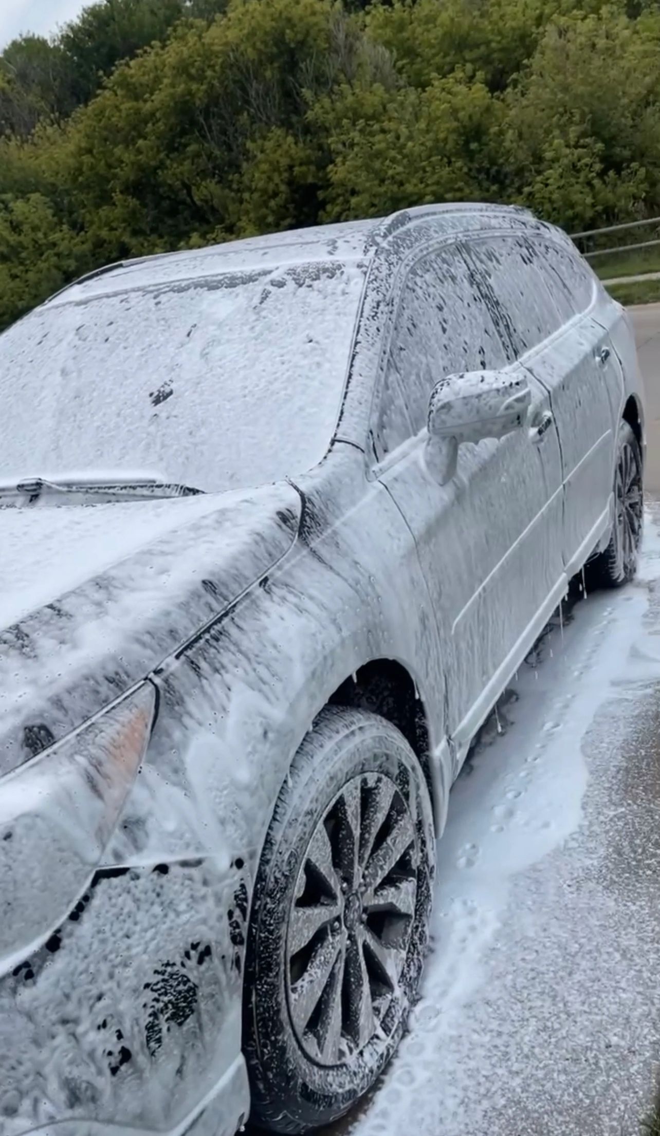 SUV mid hand-wash, covered in snow foam